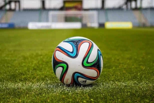 Soccer ball on grass field in stadium