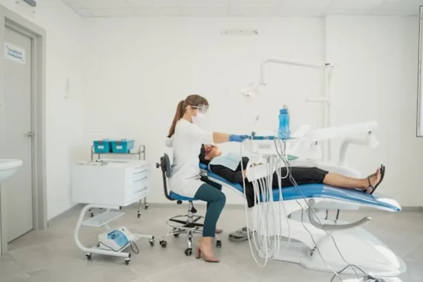 Dentist examining patient in dental clinic
