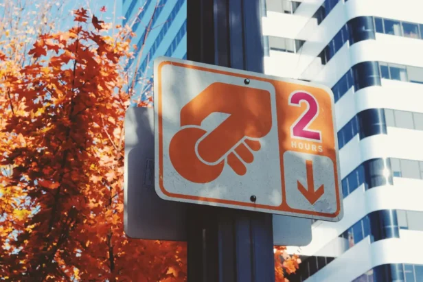 Oakland parking enforcement officers patrol downtown streets as the city implements new paid Sunday parking regulations with