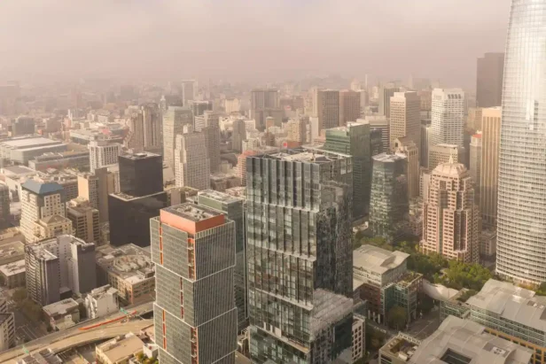 Golden Gate Bridge visible through morning fog over San Francisco cityscape downtown buildings