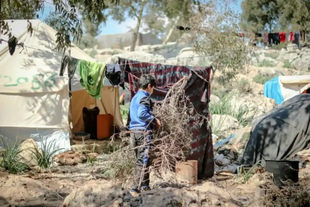Empty sidewalk with removed tent camp debris and cleared ground space.