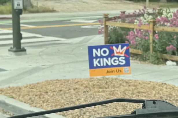 California Golden State Warriors player dribbles basketball during game against Sacramento Kings at arena.