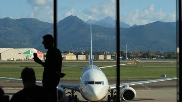 Travelers wait in line at a TSA security checkpoint at San Francisco International Airport.