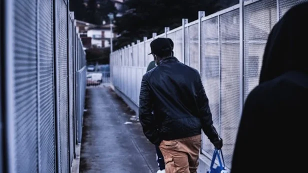 San Francisco residents wait in line at an immigration office to apply for voluntary deportation programs.